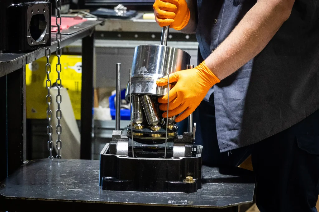 two gloved hands working with hydraulic machine at FPS